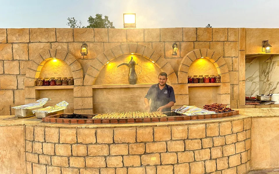 Illuminated buffet area at a Dubai desert camp