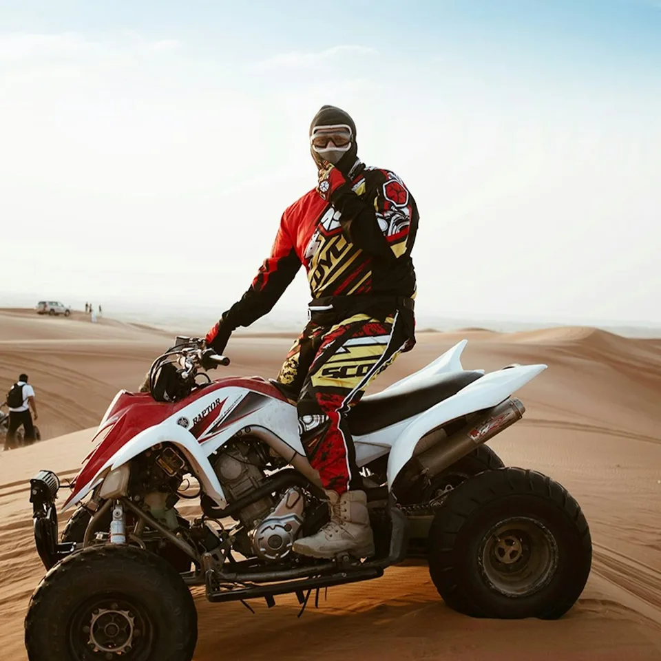 Rider on a white quad bike in the desert